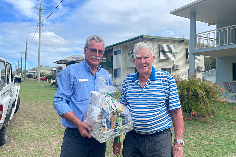 Deputy President of the RSL Pioneer-Fitzroy-Highlands District John Edwards presents a hamper to Ron Cameron, Secretary of the Seaforth RSL Sub Branch