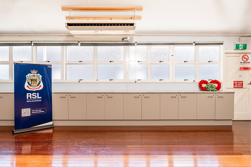 Wall with windows and cupboards. RSL Queensland banner. 