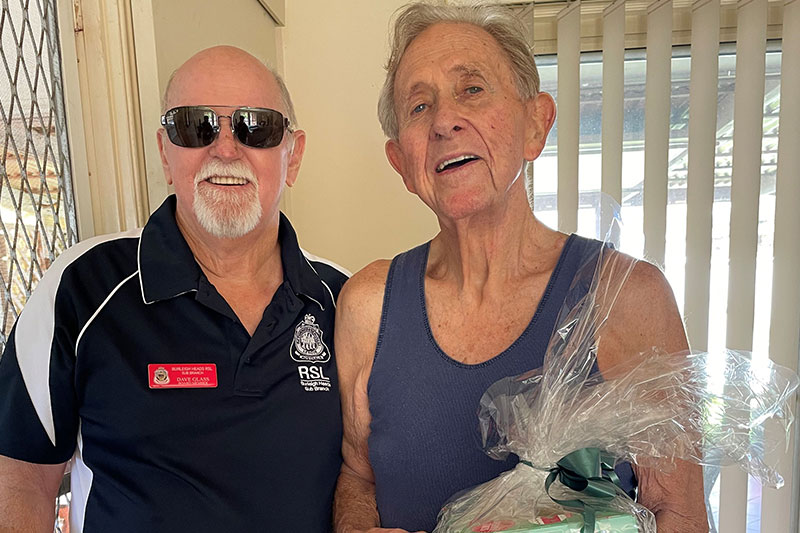 Burleigh RSL Sub Branch Board Member Dave Glass presents Don Anderson with a Christmas package