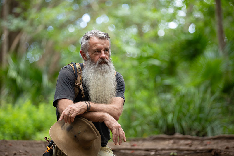 Rick Peterson sitting in nature. 