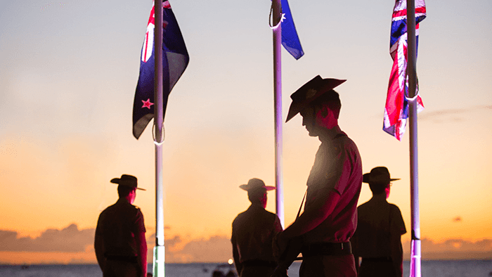 Soldiers standing with their heads bowed during a minute of silence on ANZAC Day